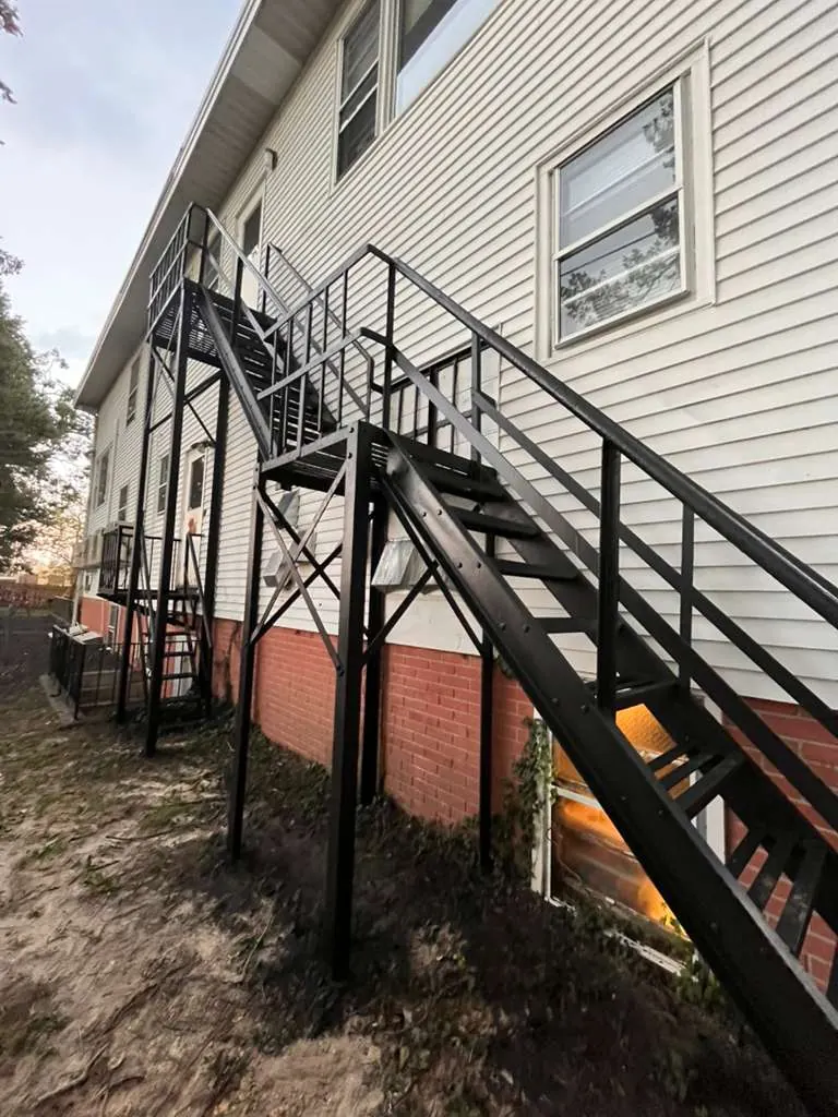 After exterior metal stair restoration with clean black finish
