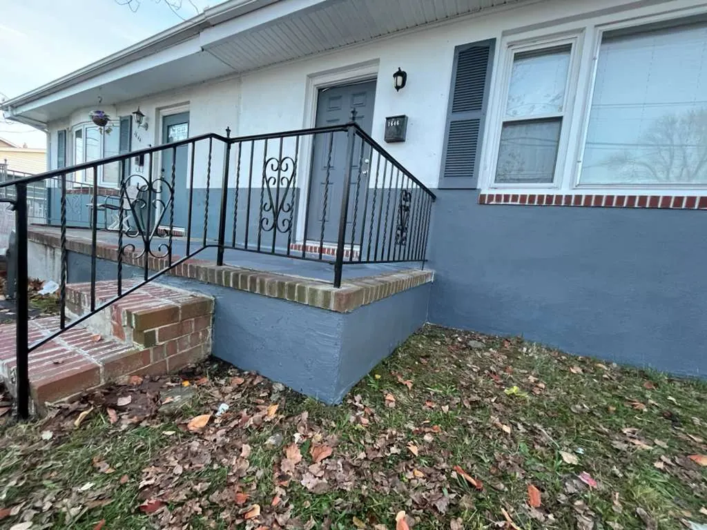 Finished front railing and entry exterior with fresh black paint