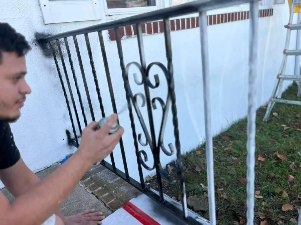 Before and process view of front iron railing being refinished